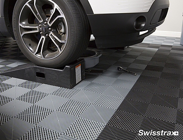Changing the oil on a car on top of Ribtrax Pro tiles