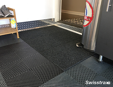 Closeup of black Ribtrax Pro Tiles in a garage